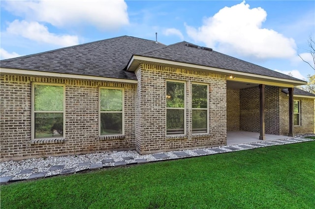 back of house featuring a patio area and a lawn