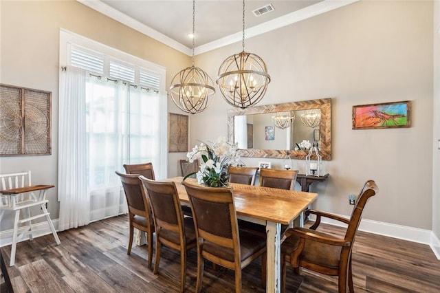 dining room featuring ornamental molding, a chandelier, and dark hardwood / wood-style flooring