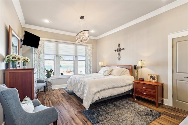 bedroom with ornamental molding, dark wood-type flooring, and a chandelier