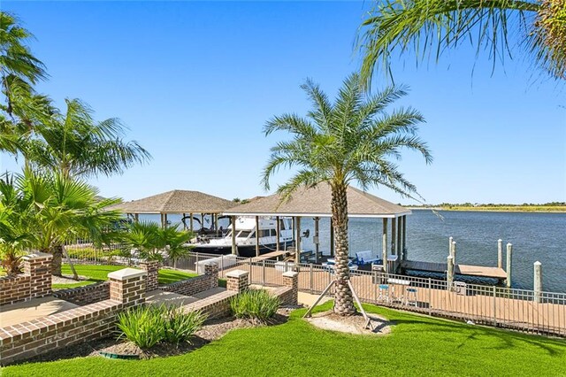 dock area featuring a water view and a lawn