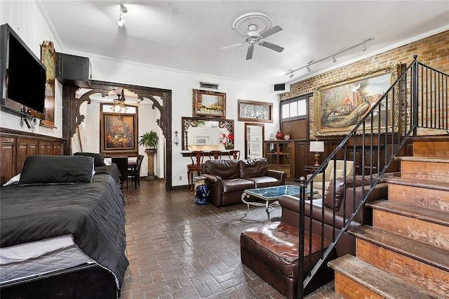 living room with rail lighting, ceiling fan, and crown molding