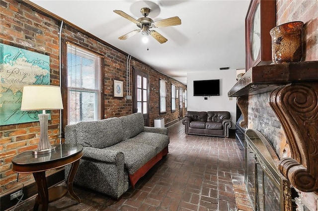 living room featuring brick wall and ceiling fan