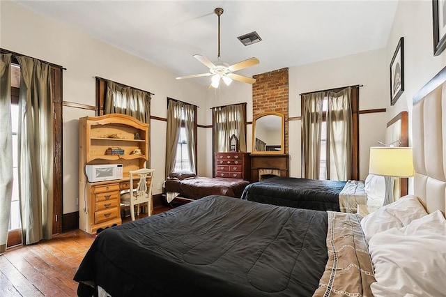 bedroom with ceiling fan and wood-type flooring