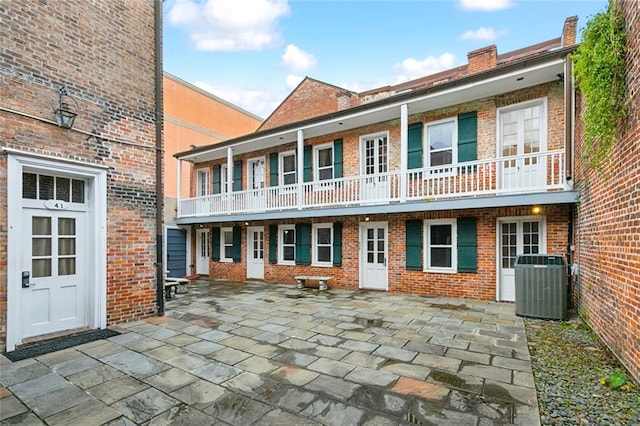 back of house featuring a patio area, central AC unit, and a balcony