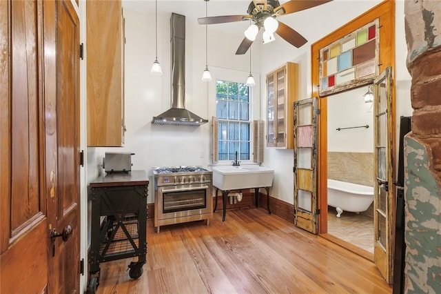 misc room featuring sink, light hardwood / wood-style flooring, and ceiling fan