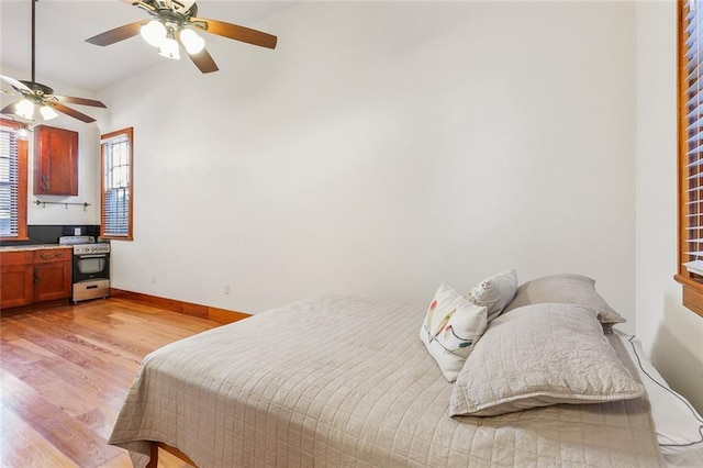 bedroom with light hardwood / wood-style flooring and ceiling fan