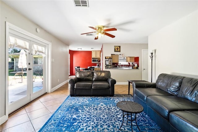 tiled living room featuring french doors and ceiling fan