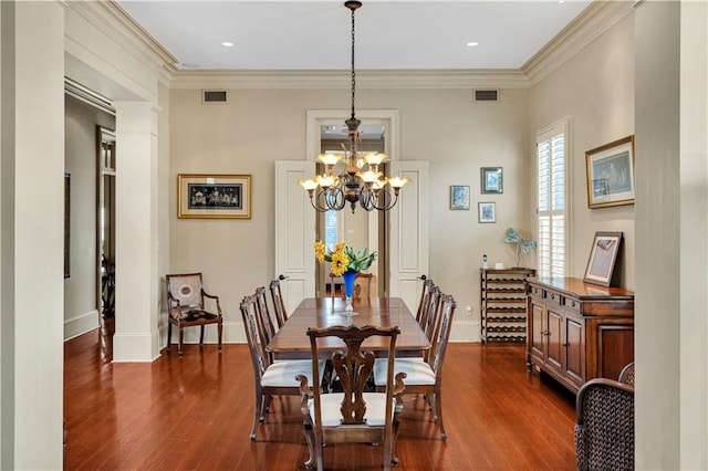 dining space featuring a notable chandelier, dark hardwood / wood-style floors, and crown molding