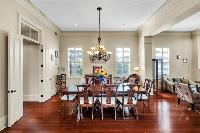 dining space featuring ornamental molding, a chandelier, and dark hardwood / wood-style floors