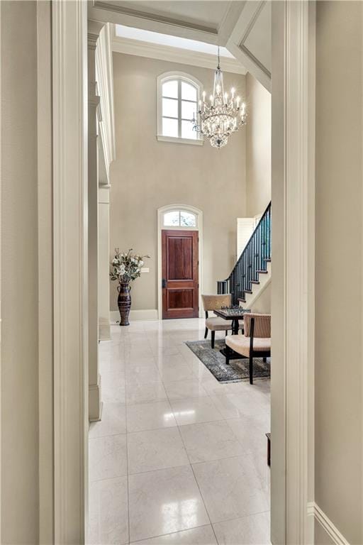 tiled foyer entrance with beam ceiling, an inviting chandelier, and high vaulted ceiling