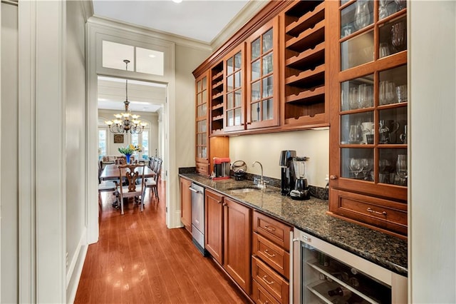 bar with wine cooler, dark stone countertops, hardwood / wood-style floors, crown molding, and a notable chandelier