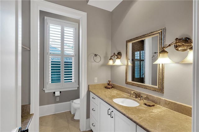 bathroom featuring tile patterned flooring, vanity, and toilet