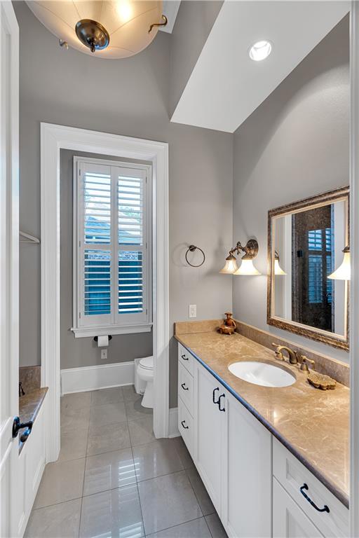 bathroom with vanity, tile patterned floors, and toilet