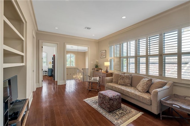 living room featuring a wealth of natural light, crown molding, and dark hardwood / wood-style flooring