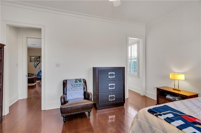 bedroom with ornamental molding, dark wood-type flooring, and ceiling fan