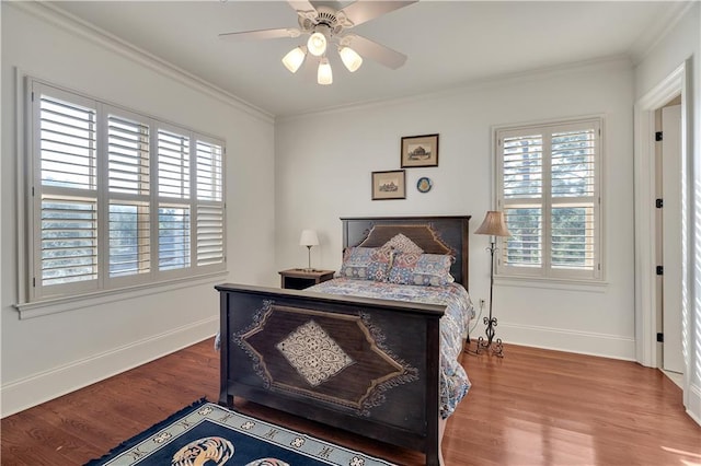 bedroom with ornamental molding, wood-type flooring, and ceiling fan