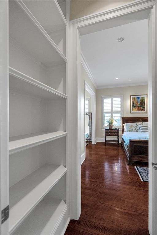 unfurnished bedroom with dark hardwood / wood-style flooring and ornamental molding