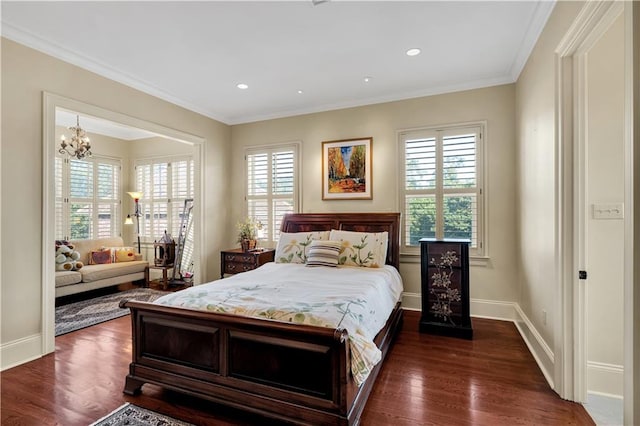 bedroom with dark hardwood / wood-style flooring, an inviting chandelier, and crown molding