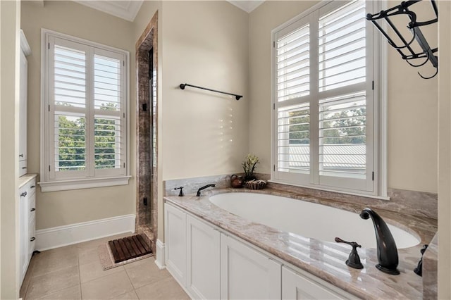 bathroom featuring a wealth of natural light, tile patterned floors, and a bathtub