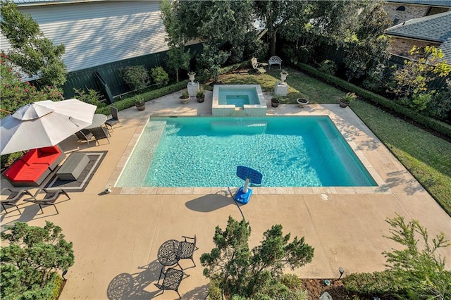 view of swimming pool featuring a patio and an in ground hot tub