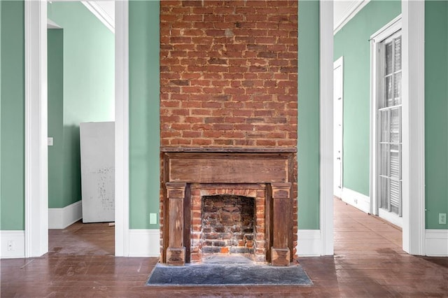 room details with hardwood / wood-style floors, a fireplace, and crown molding