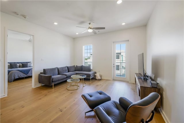 living area featuring recessed lighting, light wood-style flooring, and a ceiling fan