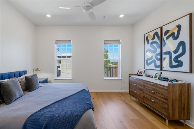 bedroom with light wood finished floors, recessed lighting, and multiple windows