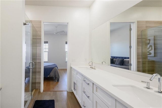 ensuite bathroom featuring a stall shower, ensuite bathroom, and a sink