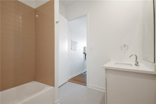 full bath featuring vanity, baseboards, and tile patterned flooring