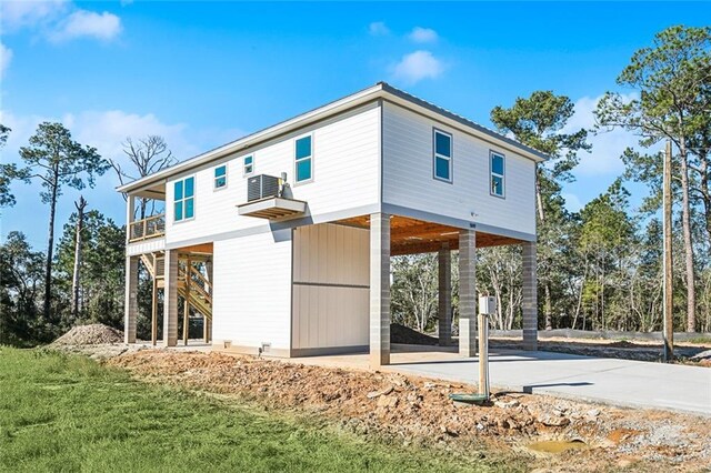 5019 Colorado St, Bay Saint Louis, MS 39520 - exterior space with a carport, stairway, concrete driveway, and a balcony