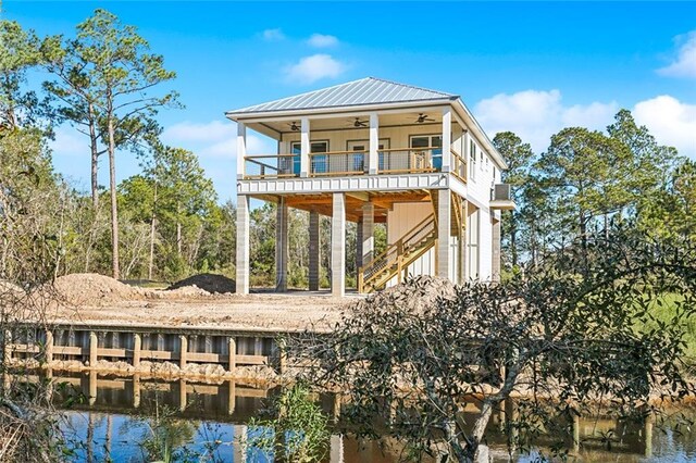 5019 Colorado St, Bay Saint Louis, MS 39520 - back of property with stairs, a ceiling fan, a water view, and metal roof