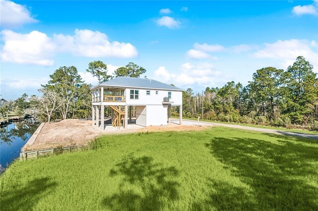 5019 Colorado St, Bay Saint Louis, MS 39520 - back of property featuring a deck, a patio area, stairway, and a lawn