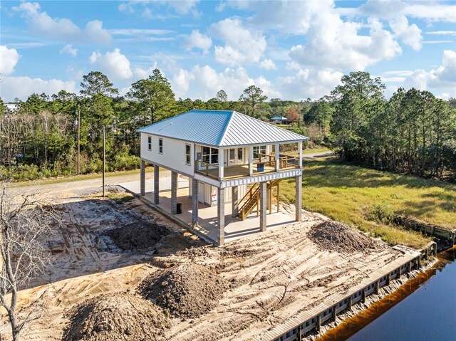 5019 Colorado St, Bay Saint Louis, MS 39520 - back of house with stairway, a patio, and metal roof