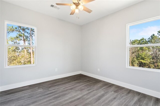 5019 Colorado St, Bay Saint Louis, MS 39520 - spare room with visible vents, a healthy amount of sunlight, baseboards, and wood finished floors