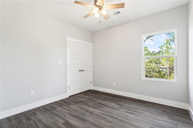 5019 Colorado St, Bay Saint Louis, MS 39520 - unfurnished room with dark wood-type flooring, baseboards, and ceiling fan