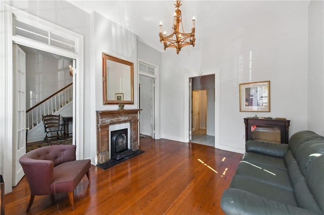 1135 Ursulines Ave, New Orleans, LA 70116 - living room with wood-type flooring and an inviting chandelier