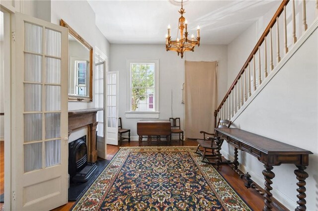 1135 Ursulines Ave, New Orleans, LA 70116 - interior space with a notable chandelier and dark hardwood / wood-style floors