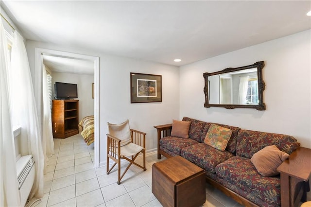 1135 Ursulines Ave, New Orleans, LA 70116 - living room featuring light tile patterned flooring and a baseboard heating unit