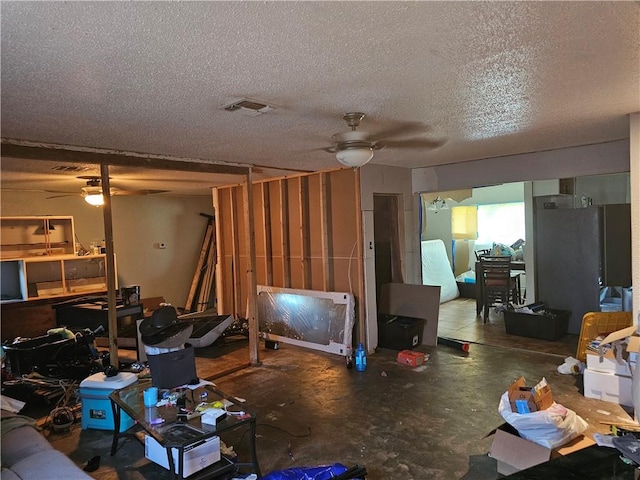 interior space with concrete flooring, a textured ceiling, and ceiling fan