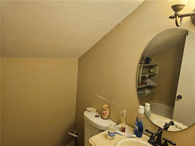 bathroom featuring sink, a textured ceiling, and toilet