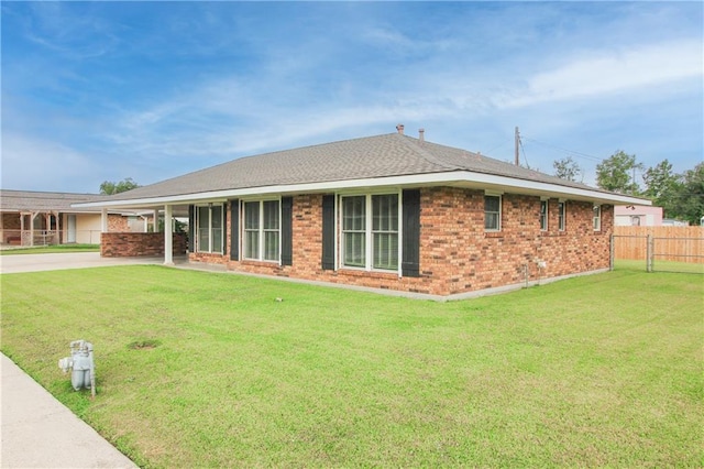 view of front of property with a front yard and a carport