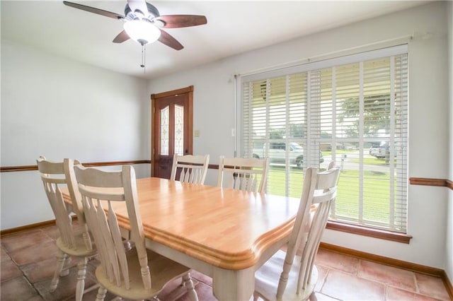 dining area with a wealth of natural light, light tile patterned floors, and ceiling fan