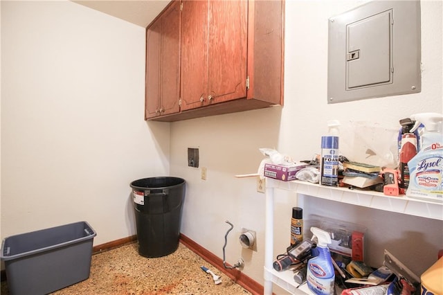 washroom featuring washer hookup, electric panel, and cabinets