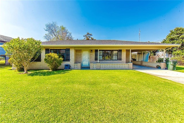 208 R J Dr, Chauvin, LA 70344 - ranch-style house with fence, concrete driveway, an attached carport, brick siding, and a front yard