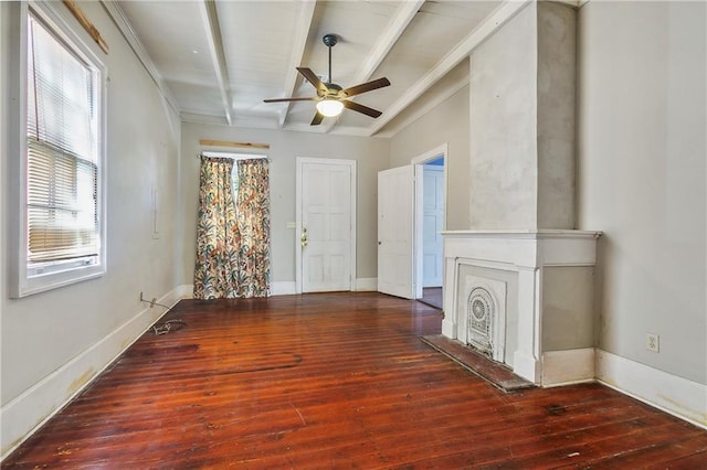 unfurnished living room featuring crown molding, beamed ceiling, dark wood-type flooring, and ceiling fan