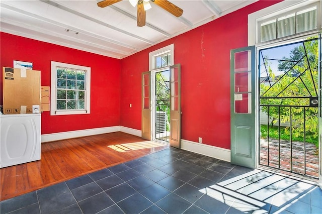 doorway to outside with beamed ceiling, dark hardwood / wood-style flooring, and plenty of natural light