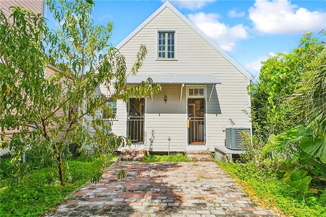 back of property featuring central AC unit