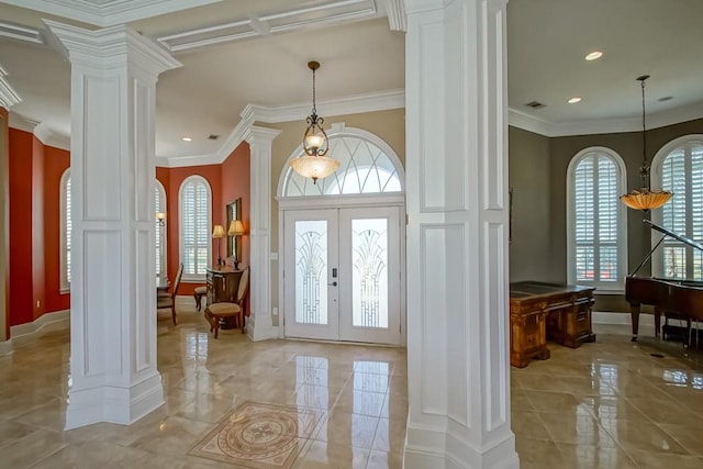 foyer with french doors, ornamental molding, a healthy amount of sunlight, and ornate columns