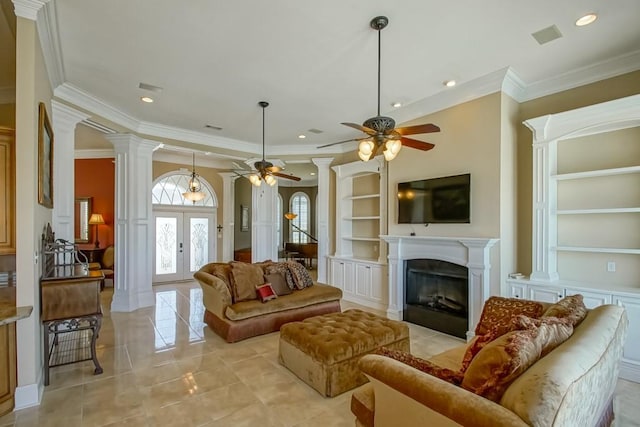 tiled living room featuring french doors, crown molding, decorative columns, built in features, and ceiling fan