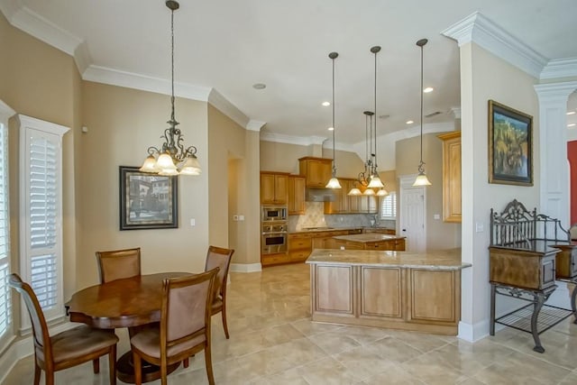 kitchen featuring appliances with stainless steel finishes, ornamental molding, and hanging light fixtures